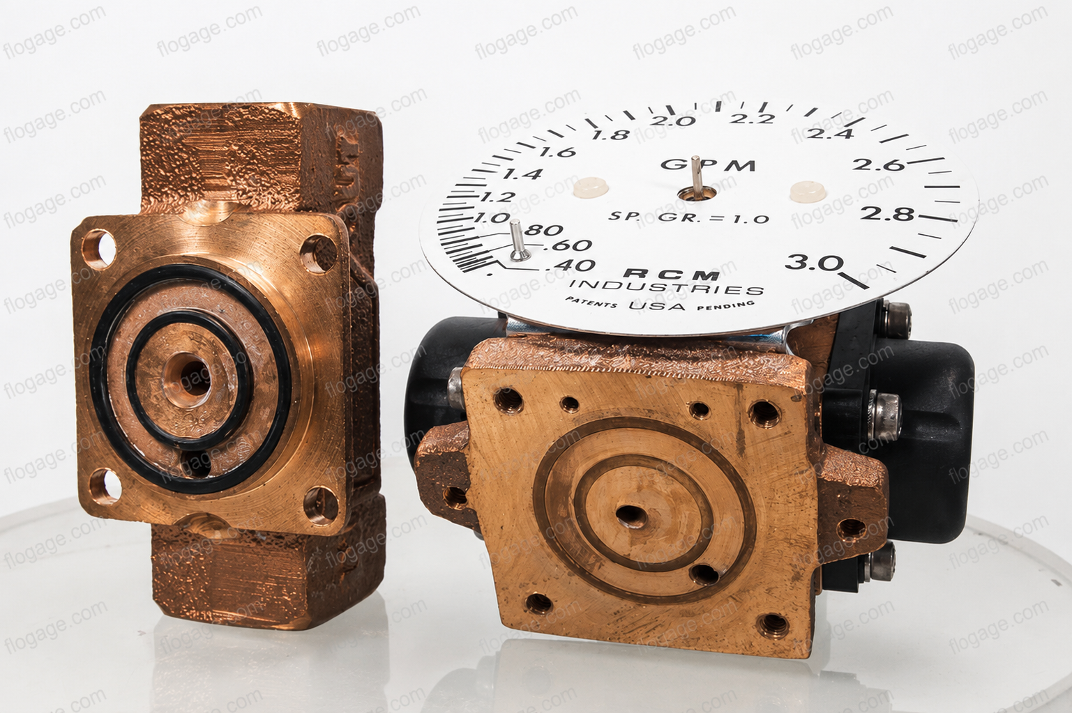 RCM Flo-Gage meter body disassembled — bronze body, dial face, and internal components
